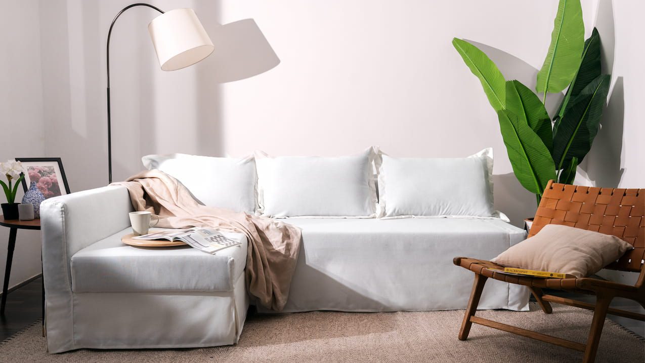 IKEA Friheten sofa bed in white slipcovers in living room