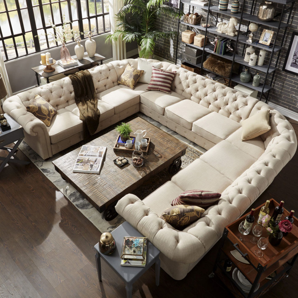 U shaped sectional in the middle of a room to fill up space and create an area for socializing.