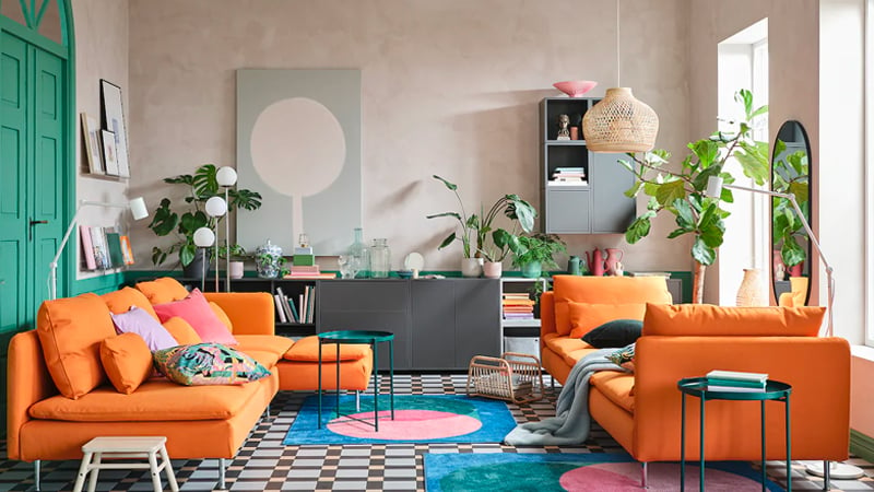 Orange IKEA sofas in a colourful living room