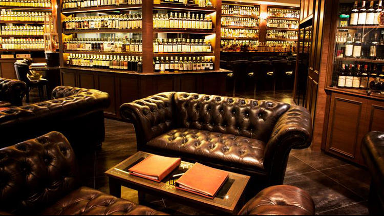 The leather Chesterfield sofa is a staple in whisky and cigar lounges