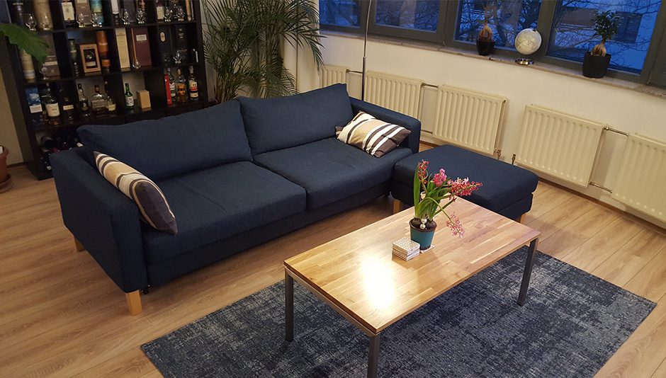 An IKEA Karlstad sofa with the footstool