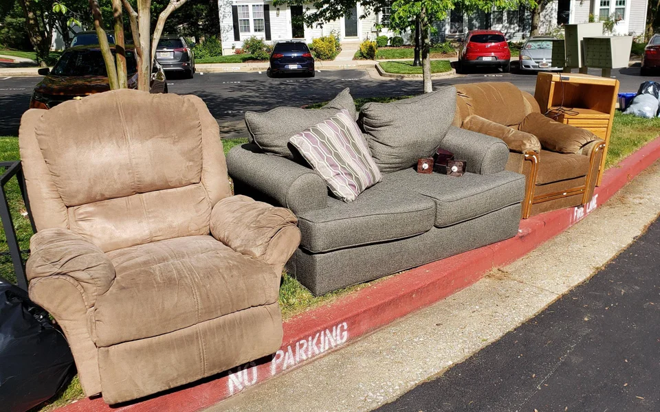 sofa on curbside of neighborhood