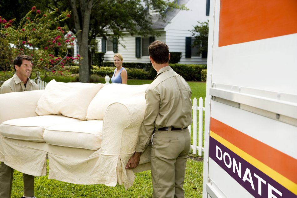 men in uniforms moving couch outdoors