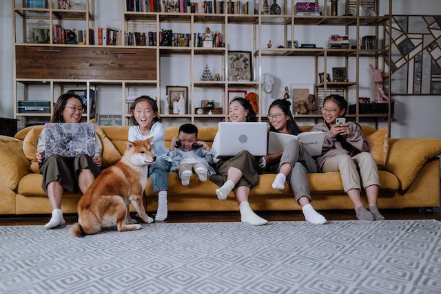 family with kids and dog on yellow couch