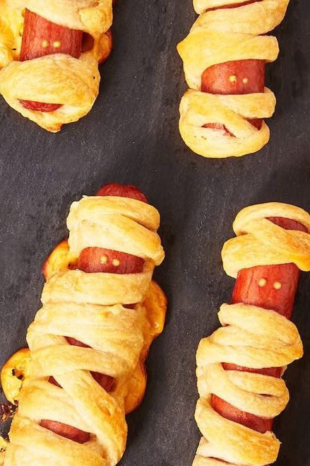 Baked hot dogs wrapped in dough that look like mummies