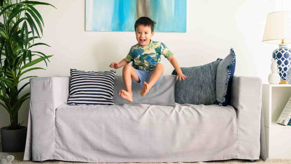 kid jumping in IKEA sofa living room best couch cover